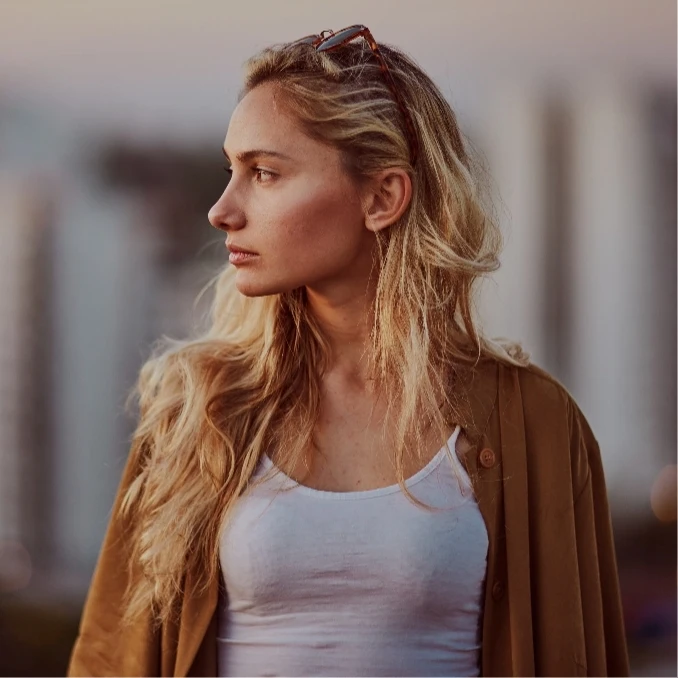 Female model in profile looking over her shoulder, Rhinoplasty in NYC