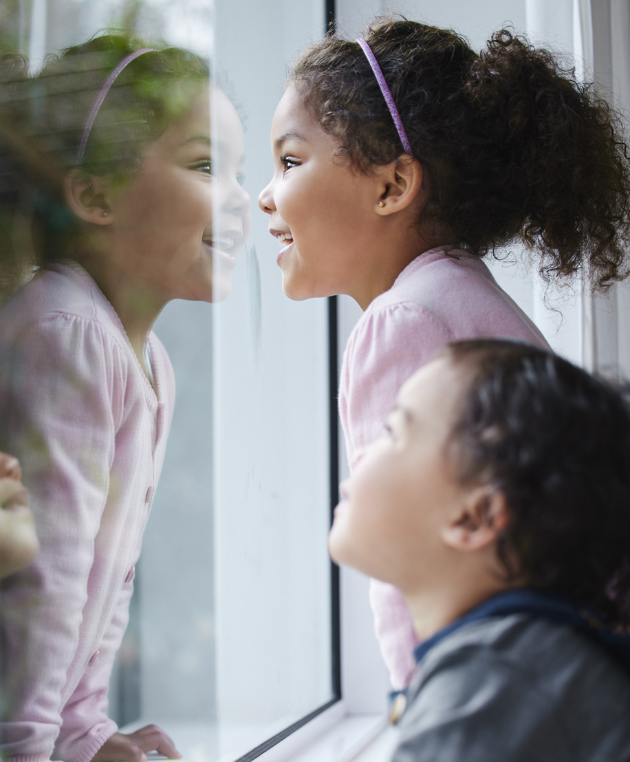 Two children looking out the window, Otoplasty in NYC